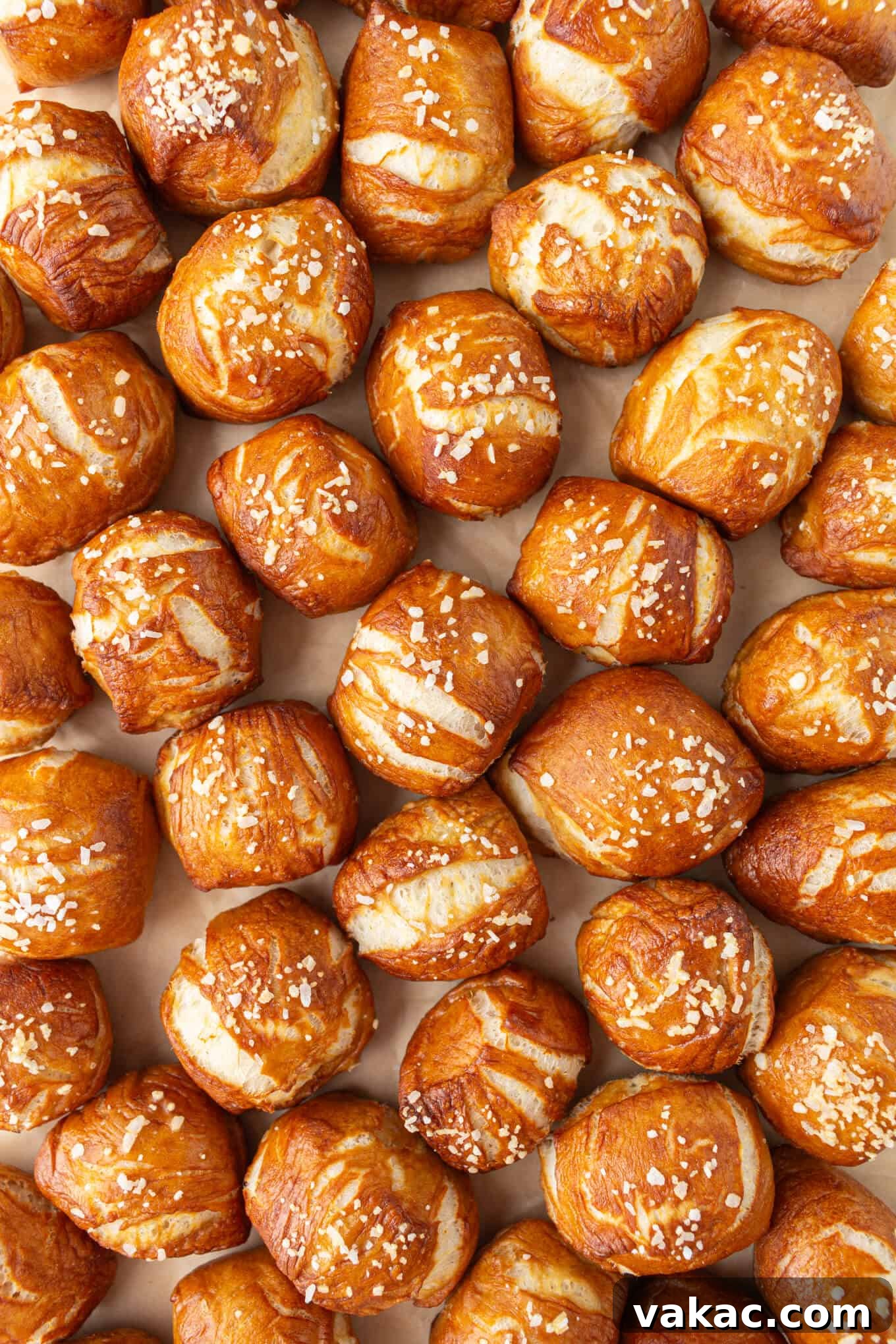 Pillowy Pretzel Gems 2 An overhead view of golden brown soft pretzel bites arranged neatly on parchment paper, ready to be enjoyed.