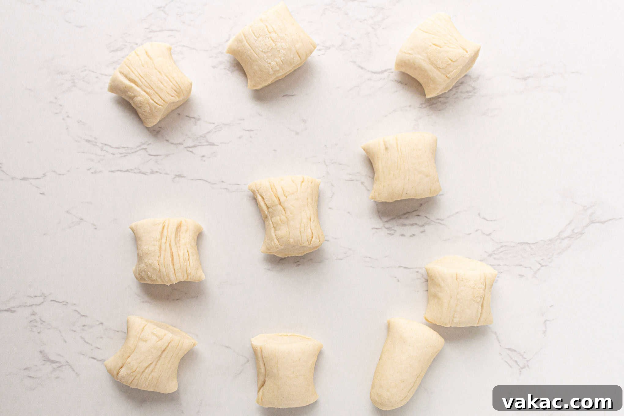 Pillowy Pretzel Gems 6 Pretzel dough, rolled into long ropes, precisely cut into small, uniform pieces on a cutting board.