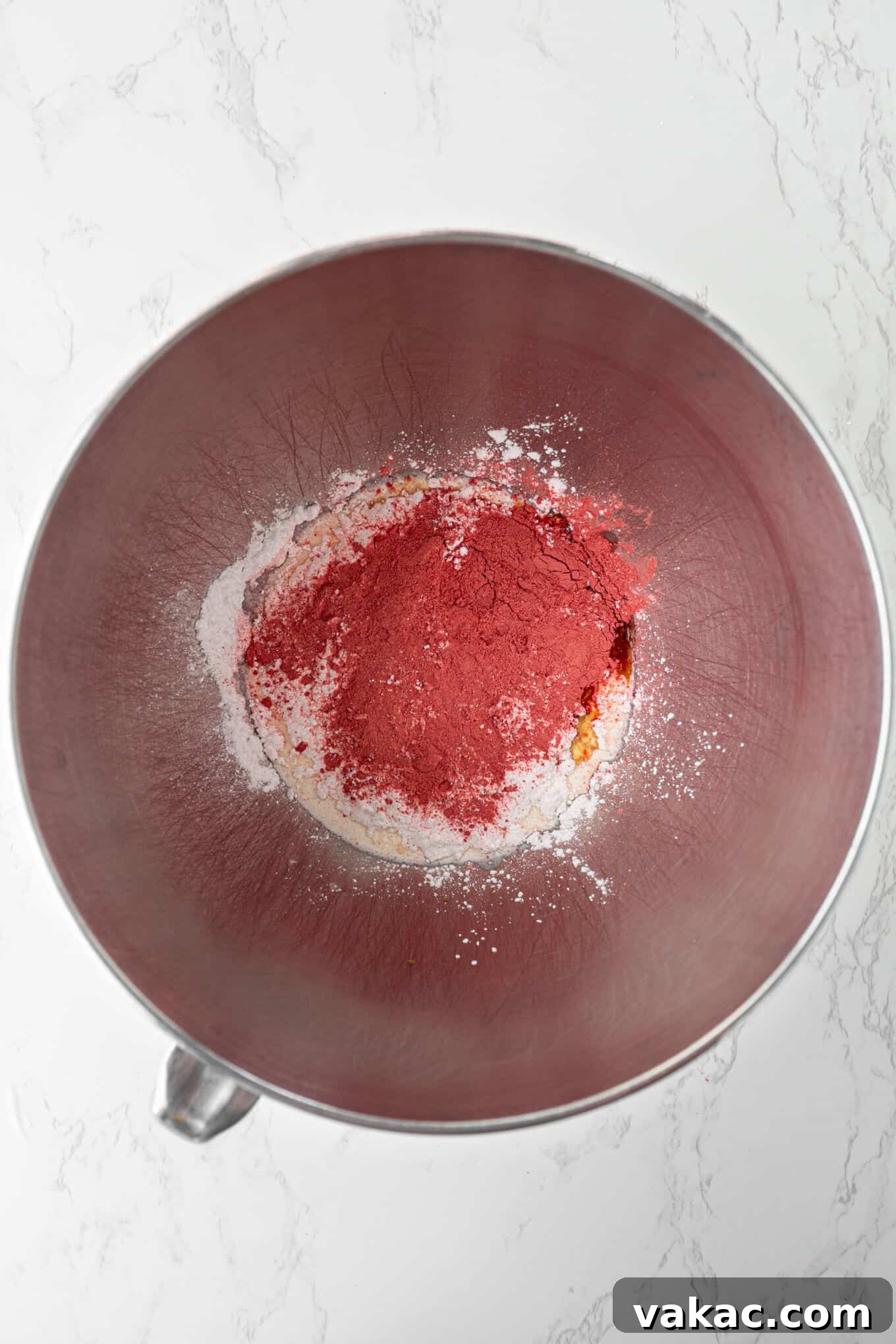 Strawberry Cloud Perfection 5 An overhead view of strawberry powder, heavy cream, vanilla, and powdered sugar in a mixing bowl before mixing.