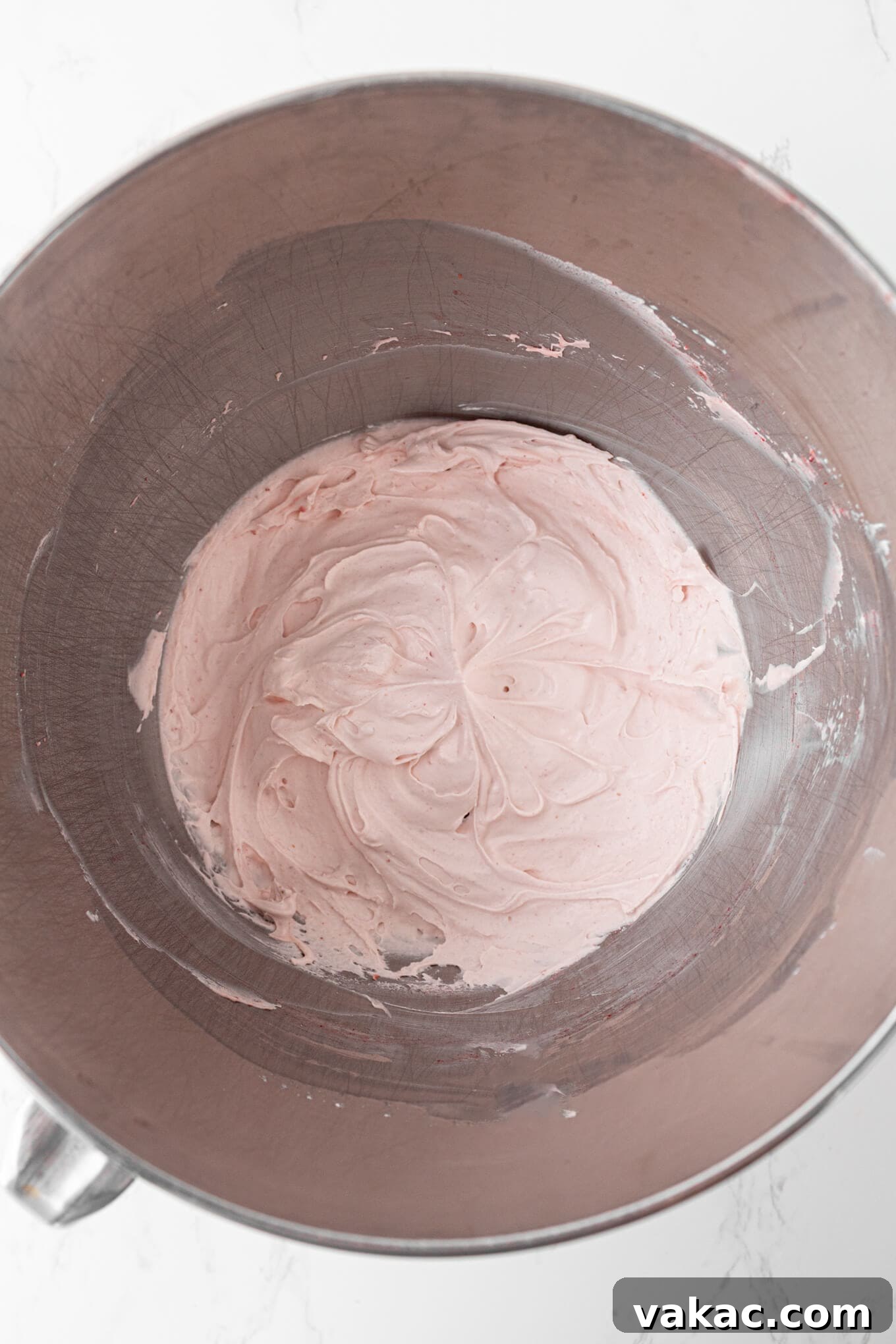 Strawberry Cloud Perfection 6 An overhead view of strawberry whipped cream in a mixing bowl, showing the finished product.