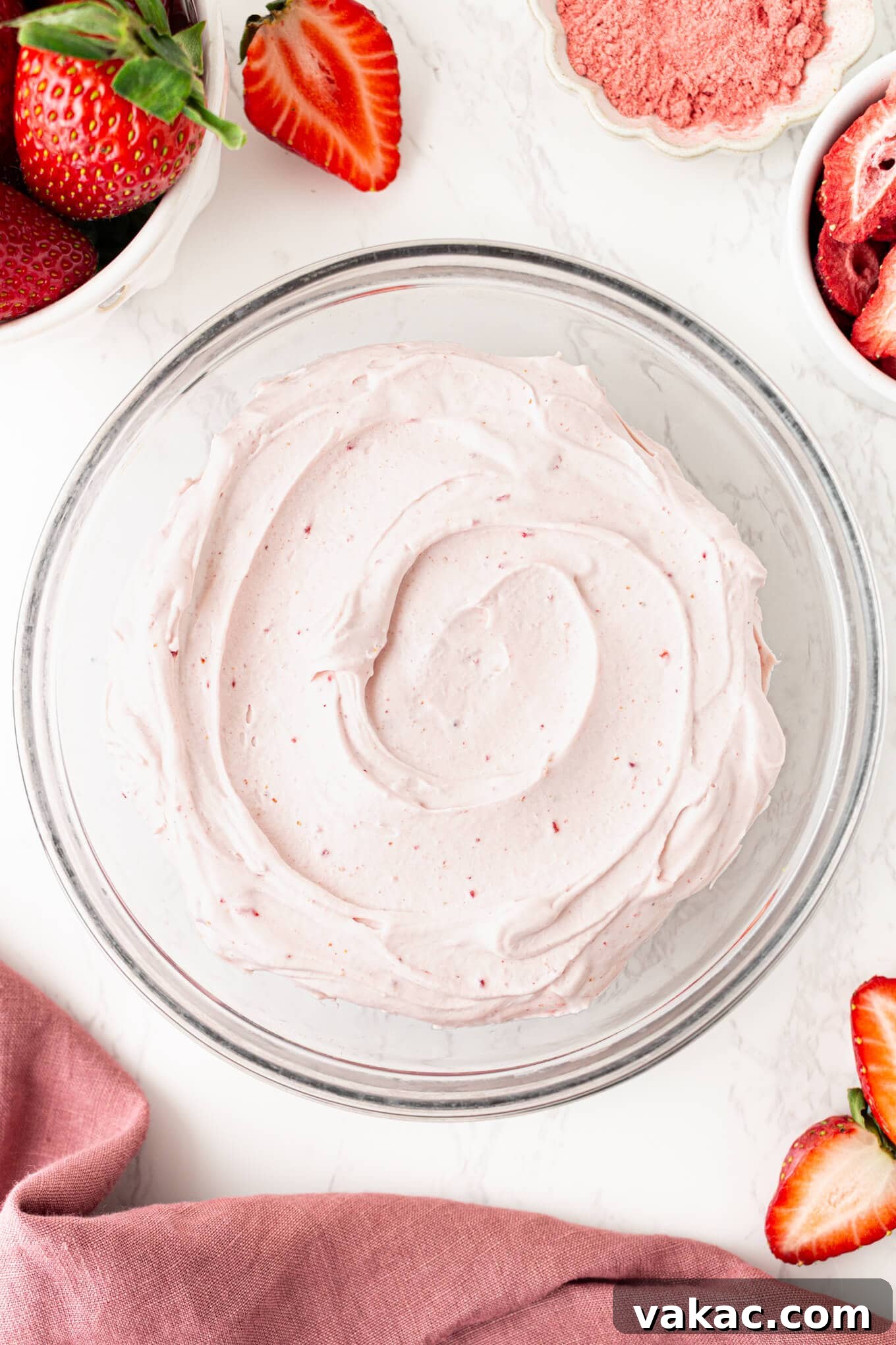 Strawberry Cloud Perfection 7 An overhead view of strawberry whipped cream in a glass mixing bowl, showcasing its volume.