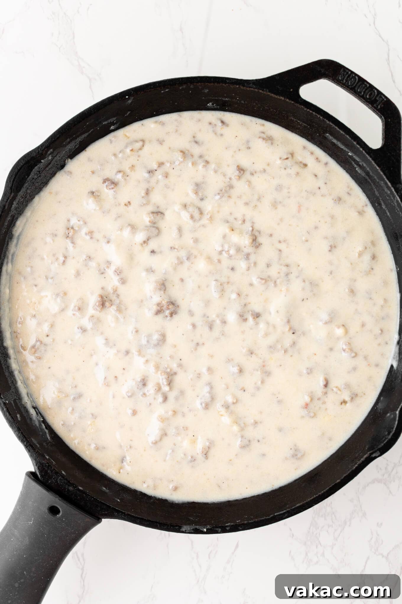 Southern Sausage Gravy Recipe for Biscuits and Breakfast 5 Overhead view of sausage gravy in a skillet.