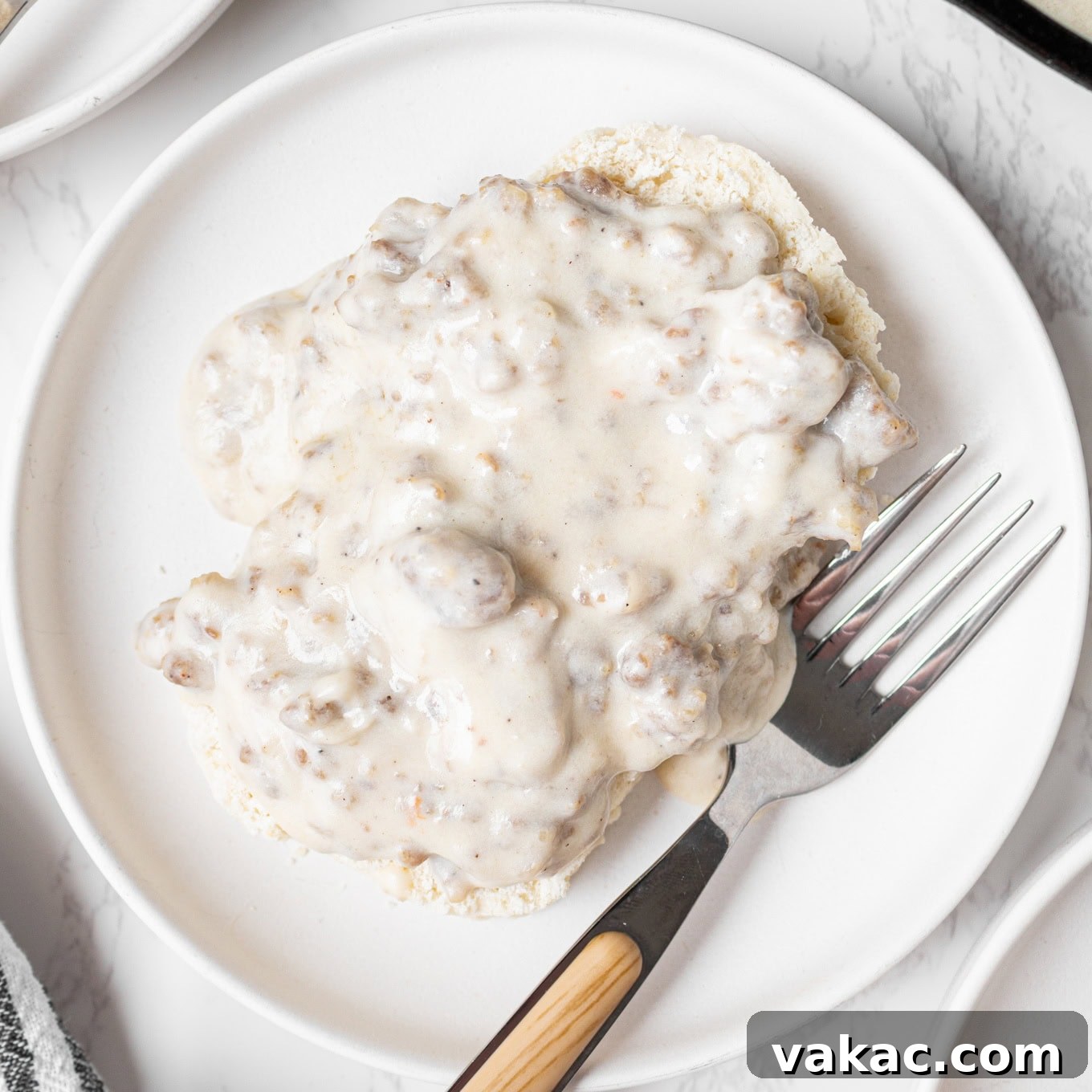 Southern Sausage Gravy Recipe for Biscuits and Breakfast 8 A biscuit topped with sausage gravy.