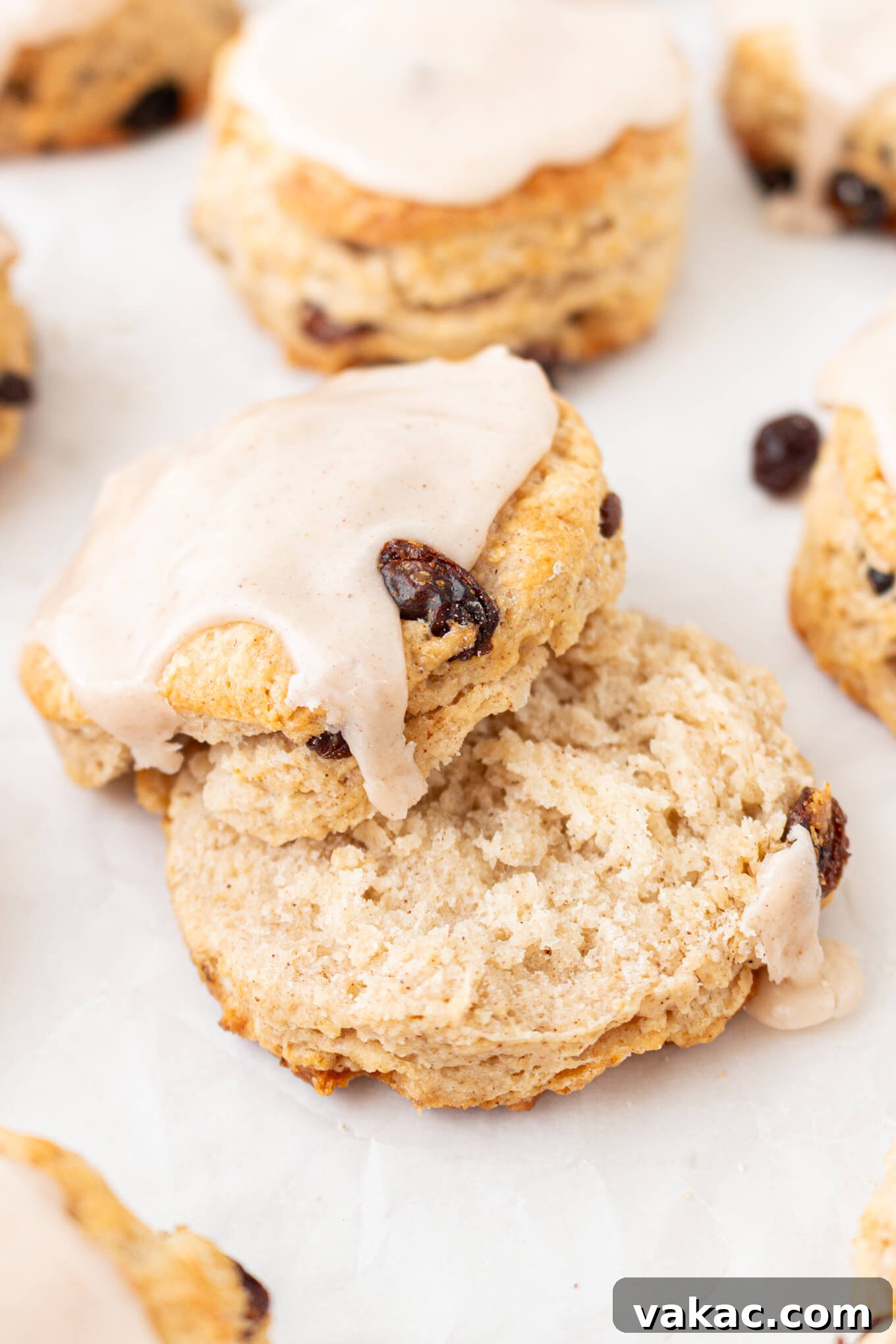 Fluffy Cinnamon Raisin Biscuits with Brown Sugar Glaze 12 An iced cinnamon raisin biscuit cut in half.
