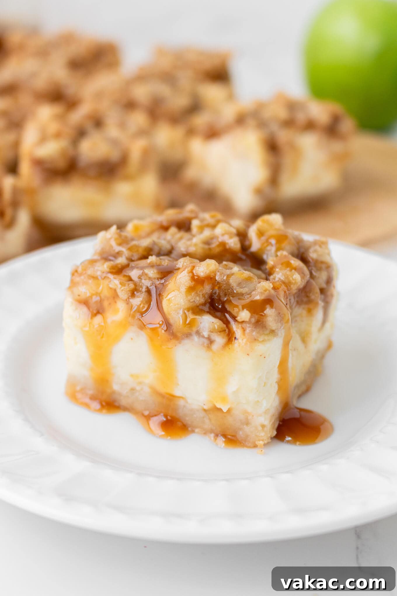 Caramel Apple Cheesecake Bars with Cinnamon Crust 2 A caramel apple cheesecake bar on a plate.