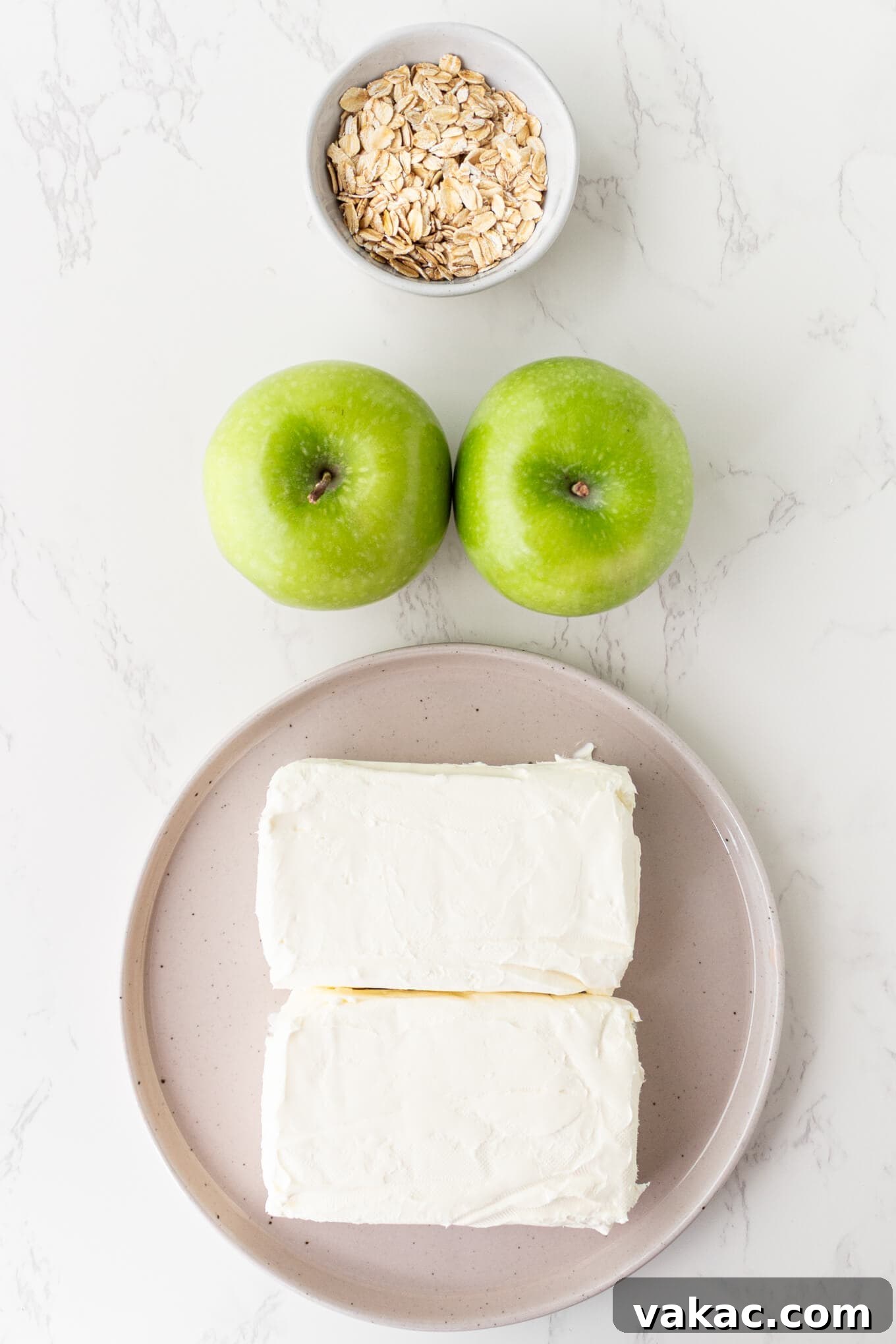 Caramel Apple Cheesecake Bars with Cinnamon Crust 3 An overhead view of oats, green apples, and cream cheese.