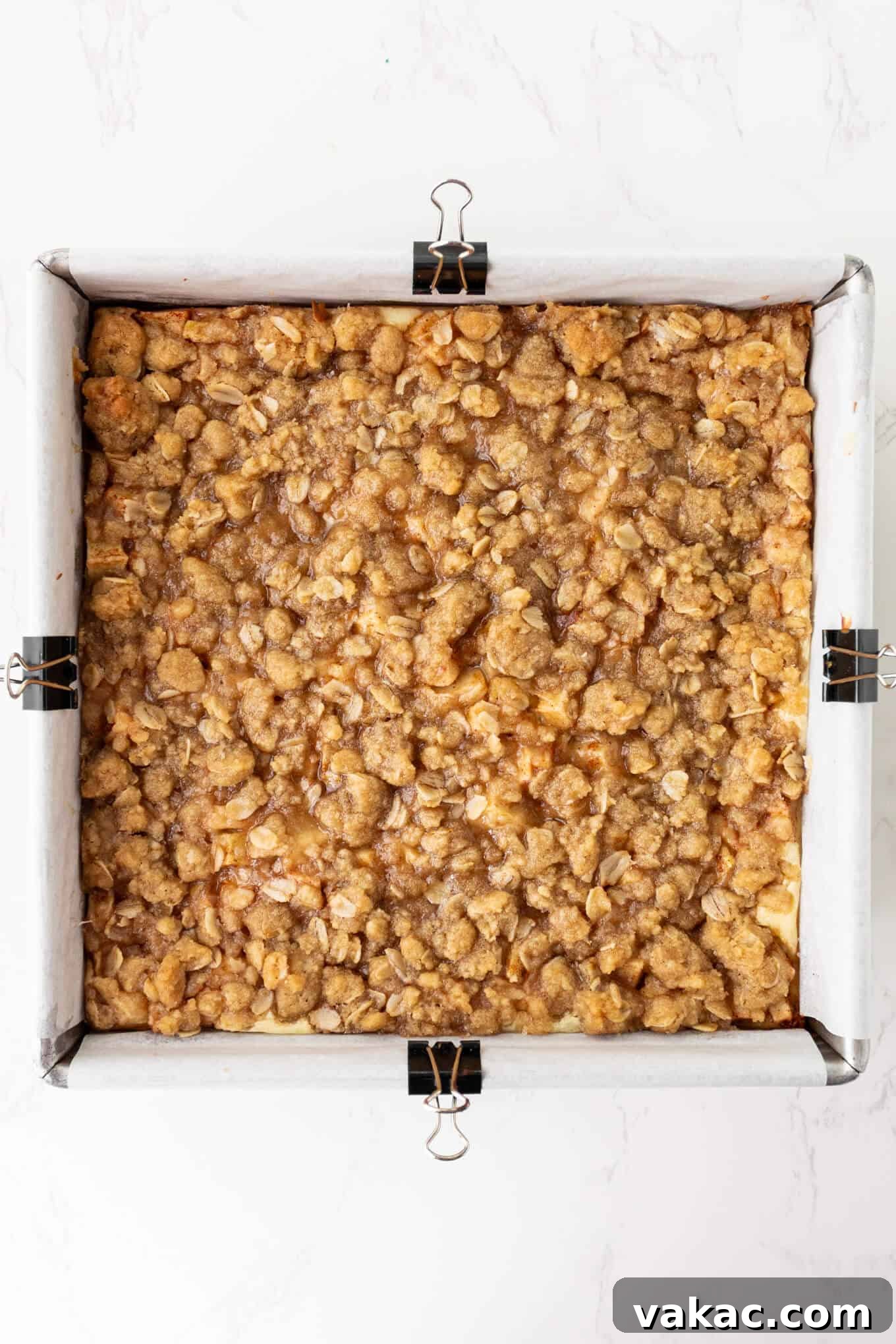 Caramel Apple Cheesecake Bars with Cinnamon Crust 7 An overhead view of apple cheesecake bars after baking.